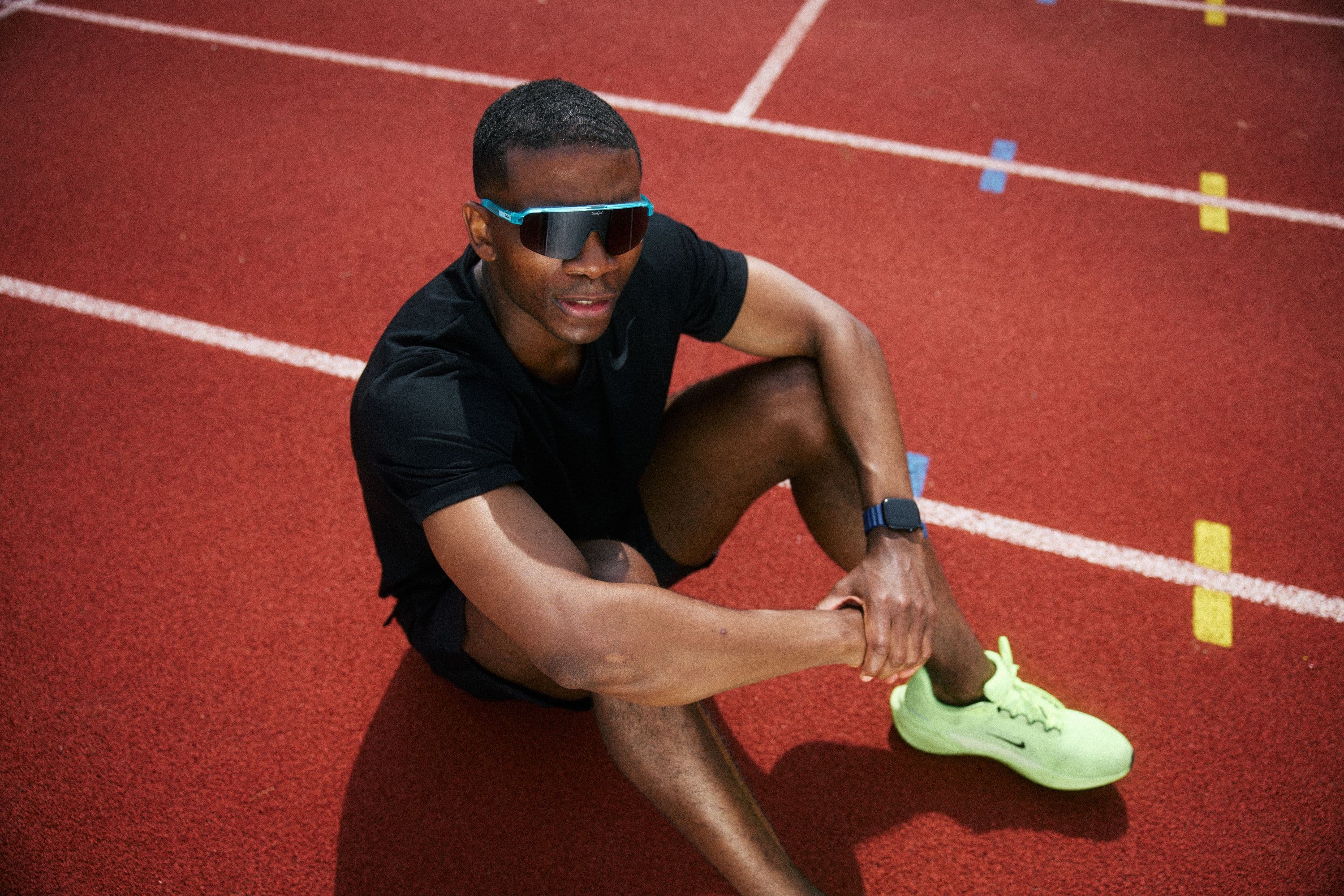 A man sat on a running track